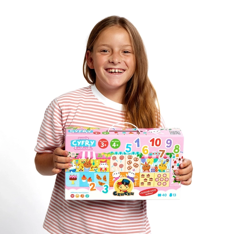 Dziecko z opakowaniem puzzli cyfry króliczki czuczu