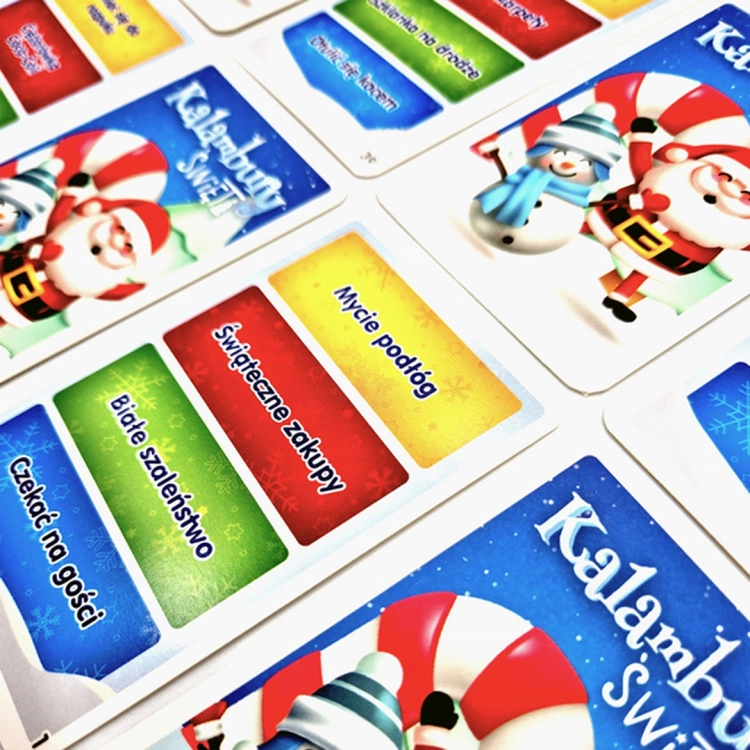 Kalambury Święta - karty z hasłami: Karty do gry "Kalambury Święta" z różnorodnymi świątecznymi hasłami, takimi jak "Mycie podłóg" i "Świąteczne zakupy", na kolorowym tle.