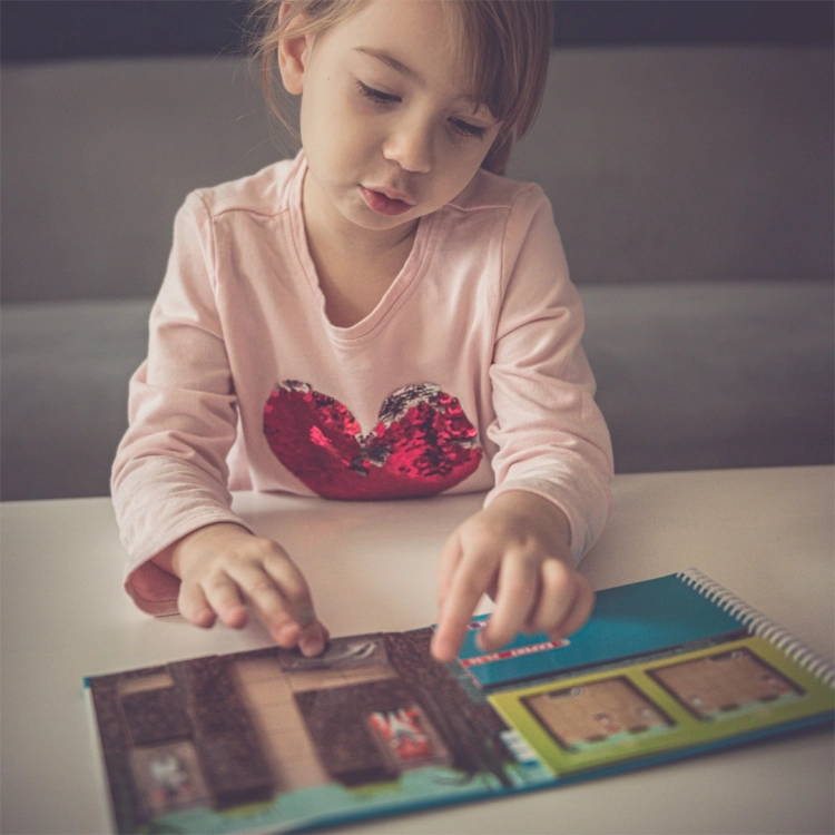 Dziewczynka grająca w Króliczą Norkę przy stole