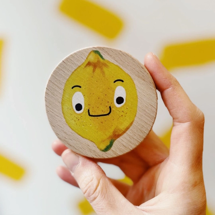 Drewniana gra memo z cytryną o uśmiechniętej buzi.