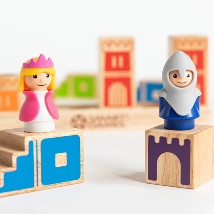 figurki księżniczki i rycerza z gry Kamelot Junior na tle zamku z klocków