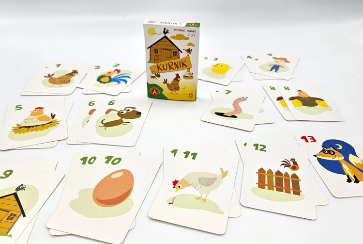 Rozłożone karty z gry Piotruś Pamięć Kurnik ukazujące różnorodne ilustracje zwierząt i przedmiotów z farmy, obok pudełka.