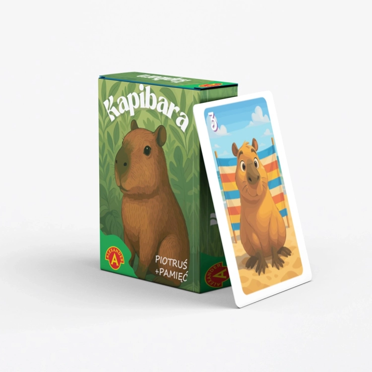 Pudełko gry "Piotruś Pamięć Kapibara" obok karty z kapibarą na plaży.