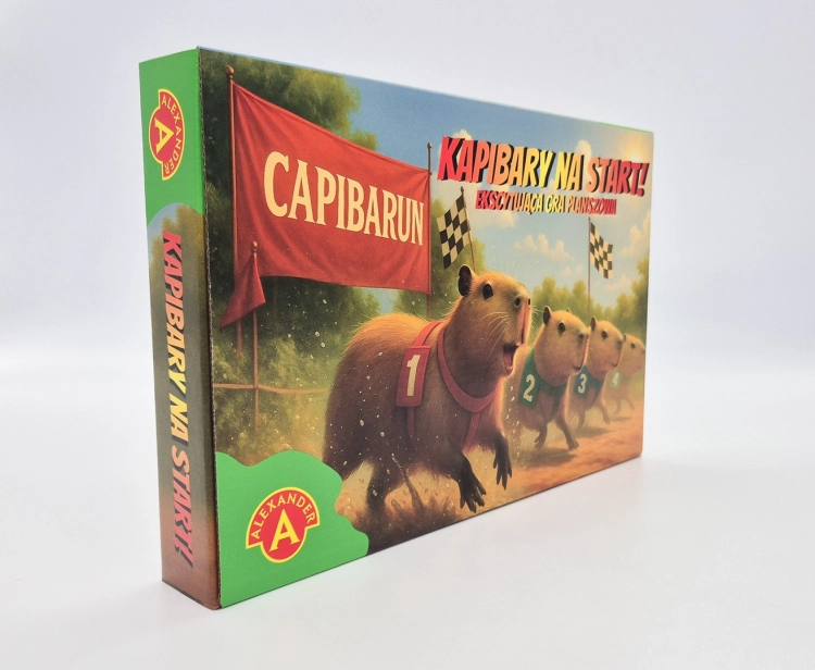Pudełko gry planszowej "Kapibary na Start" z boku, ukazujące grafikę biegnących kapibar.