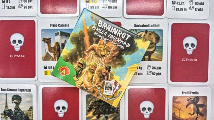 Karciana gra Brainrot Mega Zadymka, pudełko otoczone kartami na stole.