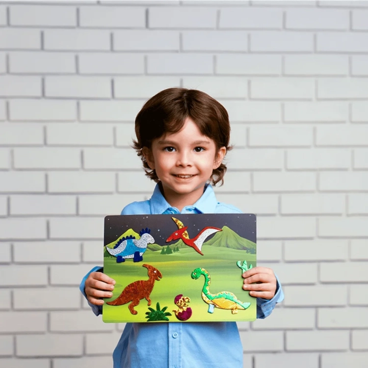 Uśmiechnięty chłopiec trzyma ozdobiony obrazek z dinozaurami z zestawu Skillmatics Foil Fun.