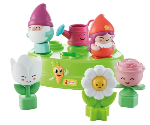 Zestaw edukacyjny: zielona podstawa sortera oraz figurki krasnali, kwiatuszków i konewki o różnych kształtach geometrycznych u dołu.