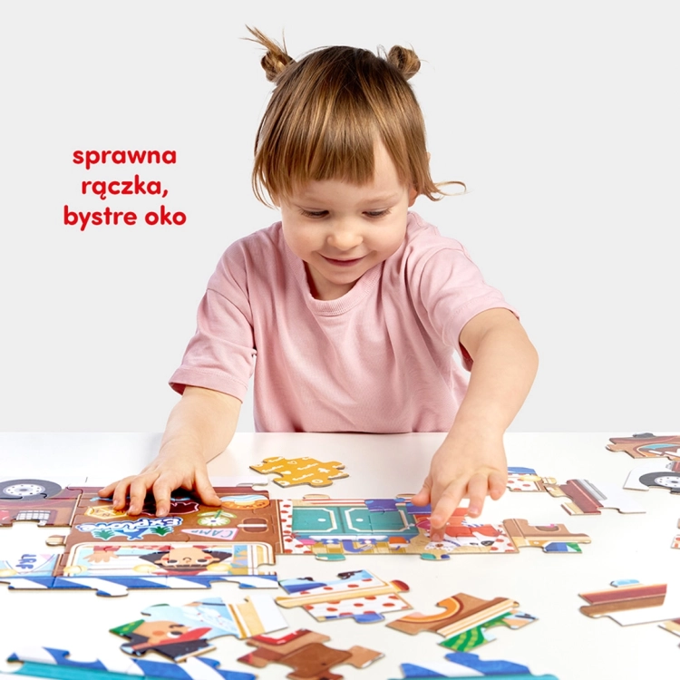 Dziecko siedzi przy stole i układa kolorowe elementy puzzli z motywem kampera. Napis: „sprawna rączka, bystre oko”.