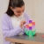 Dziewczynka układająca kolorowy kwiat z klocków magnetycznych Connetix PRO Build It 4 Ways Flowers Pack