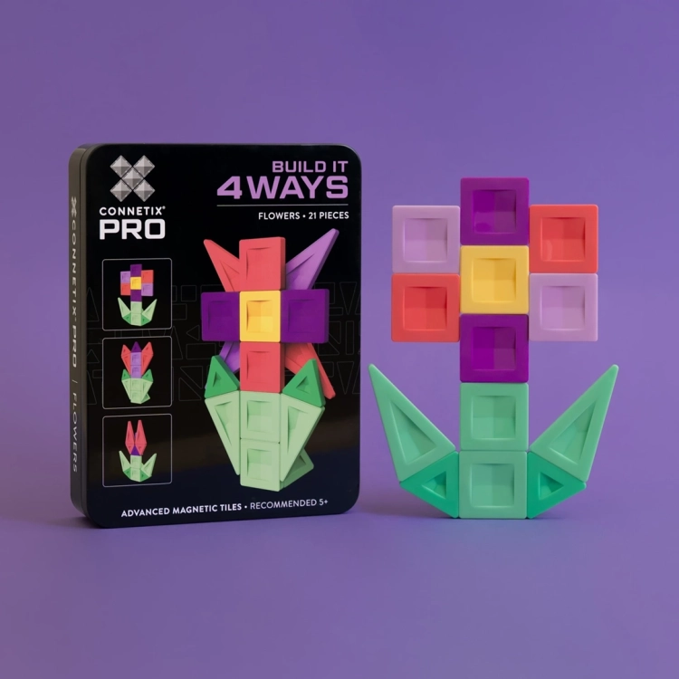 Klocki magnetyczne Connetix PRO Build It 4 Ways Flowers Pack ułożone w kwiat obok czarnego pudełka